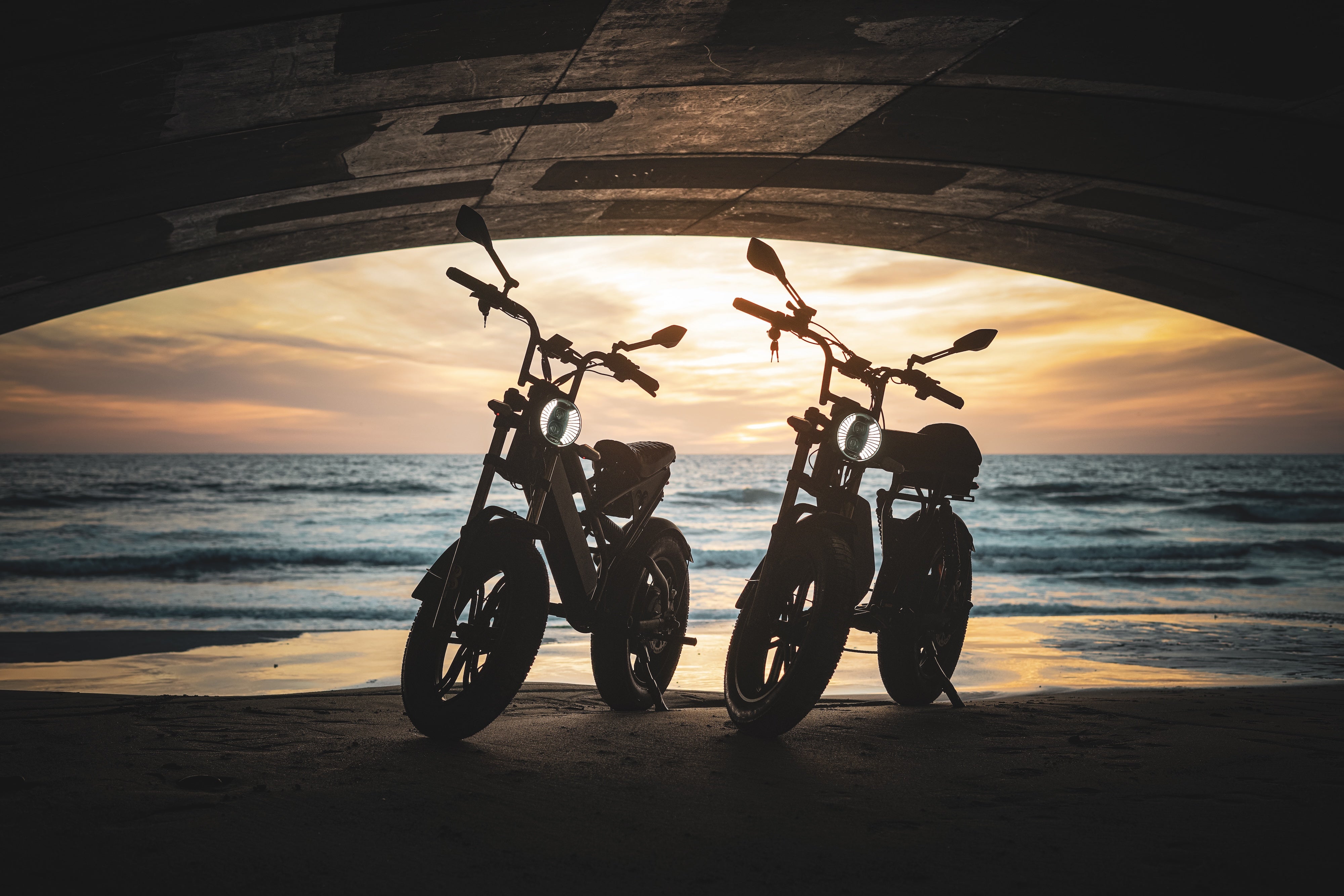 electric bikes on beach at suset