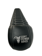 Black electric bike seat with 'Goat Power Bikes' logo on a white background